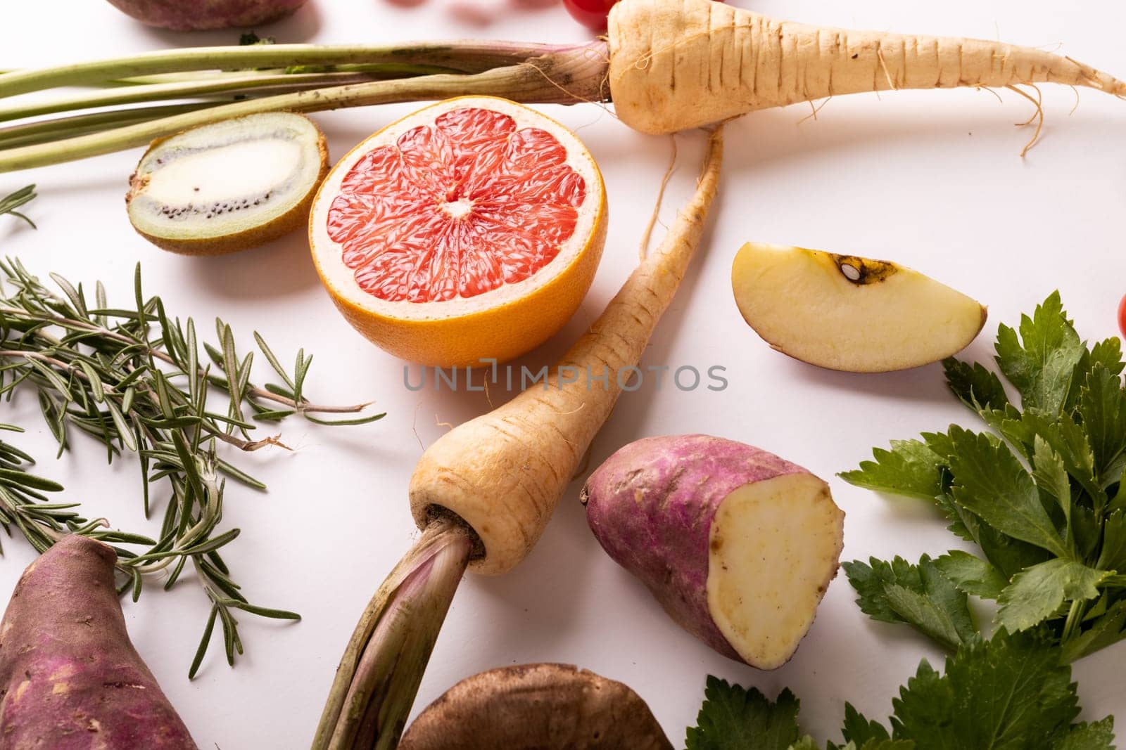 High angle close-up view of fresh vegetables and fruits on white background by Wavebreakmedia