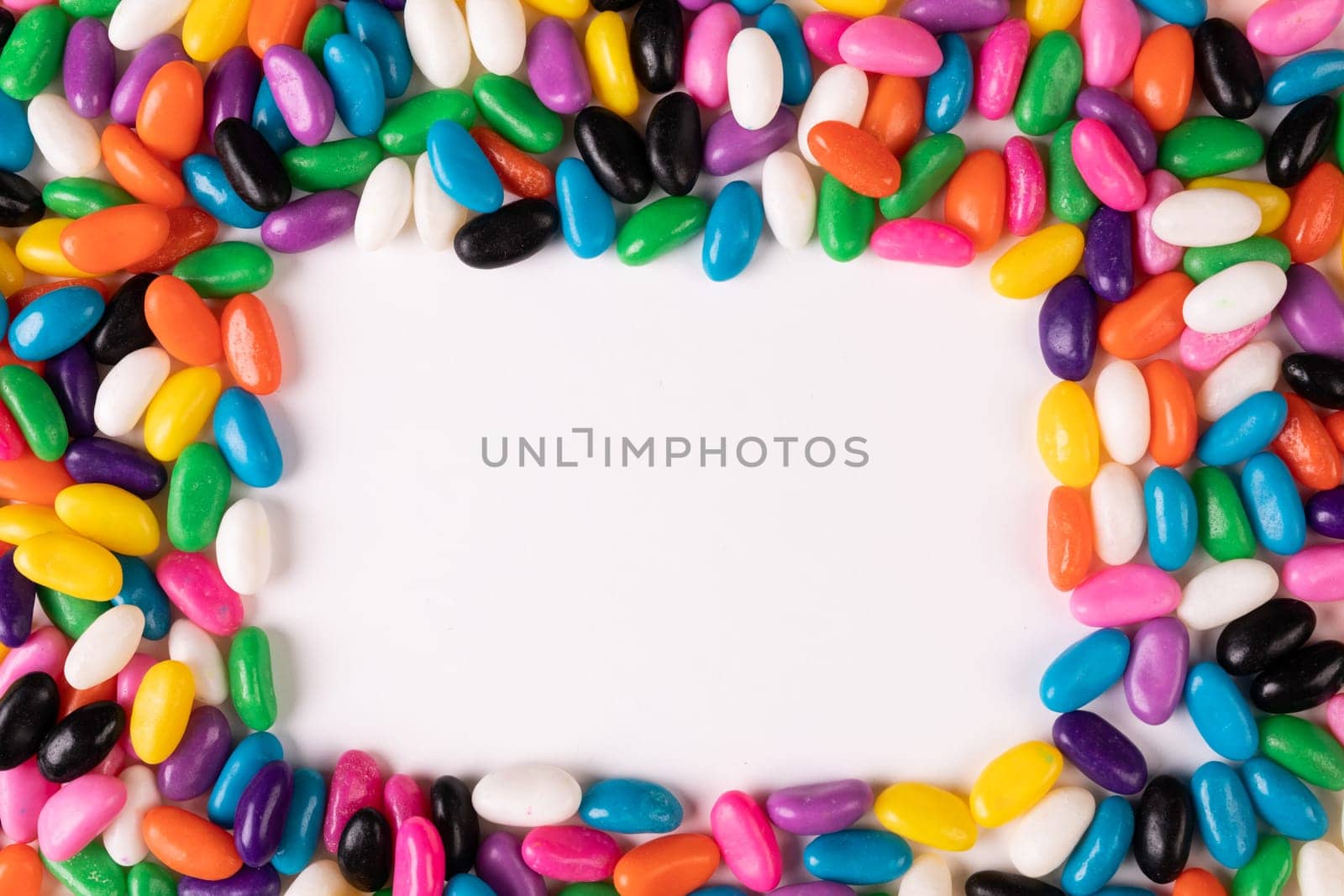 Overhead view of copy space amidst multi colored candies over white background by Wavebreakmedia