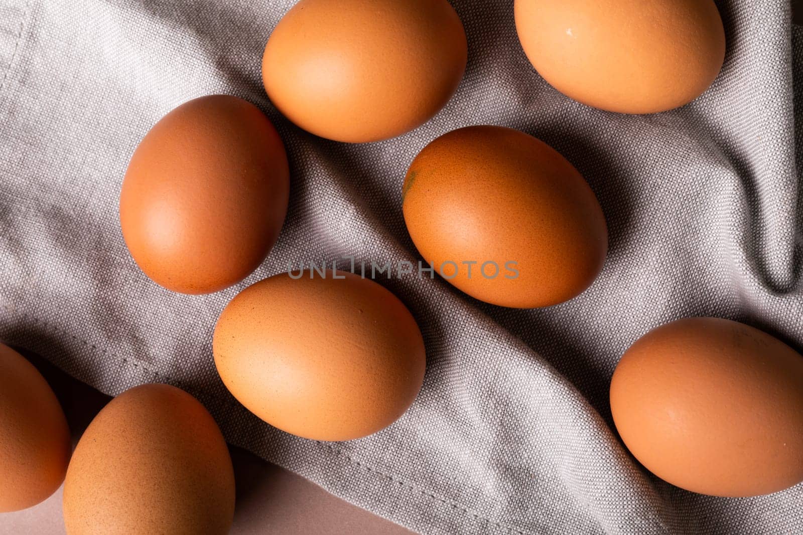 Directly above view of fresh brown eggs on gray napkin. unaltered, food, healthy eating concept.