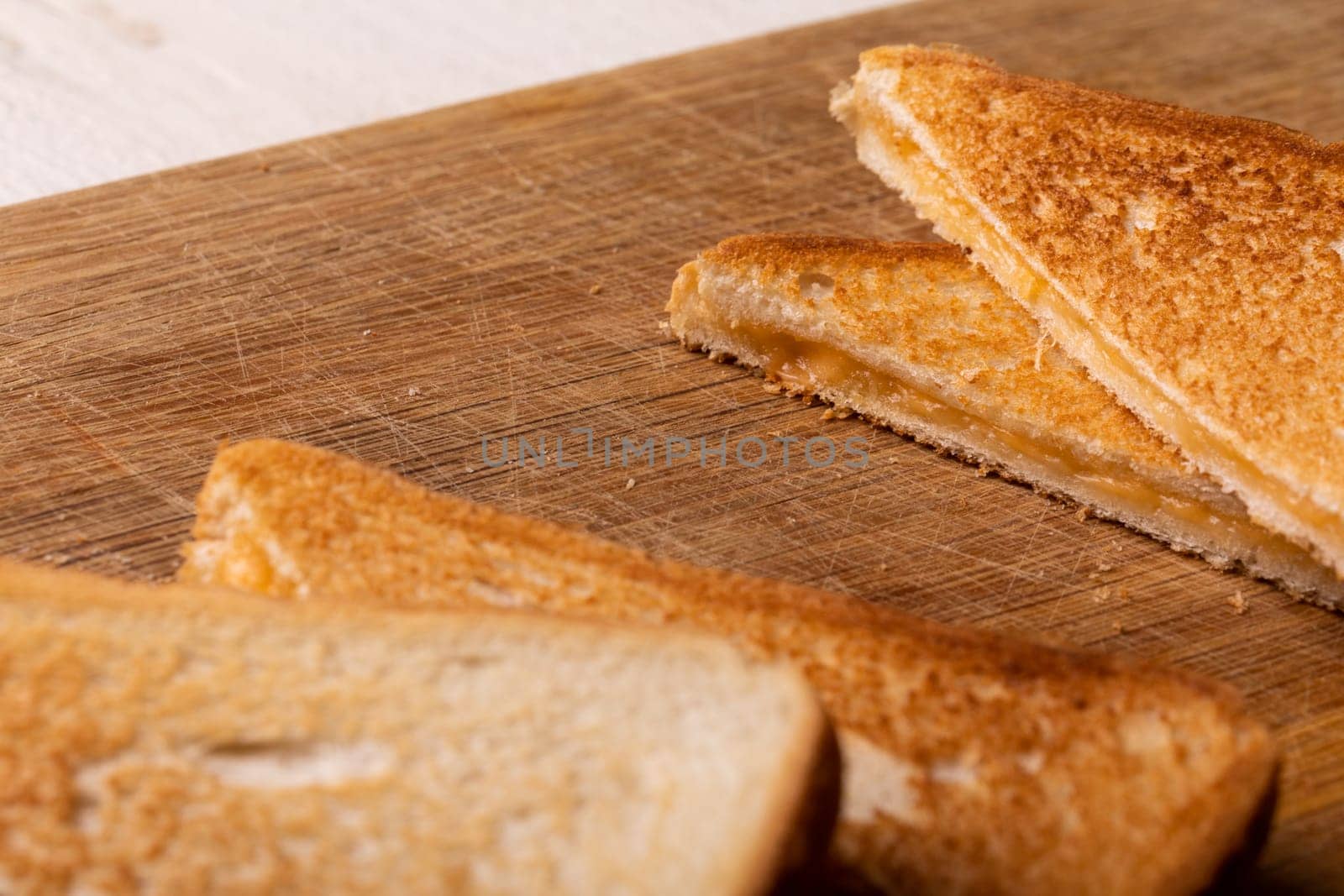 Close-up of fresh cheese sandwich on wooden serving board by Wavebreakmedia