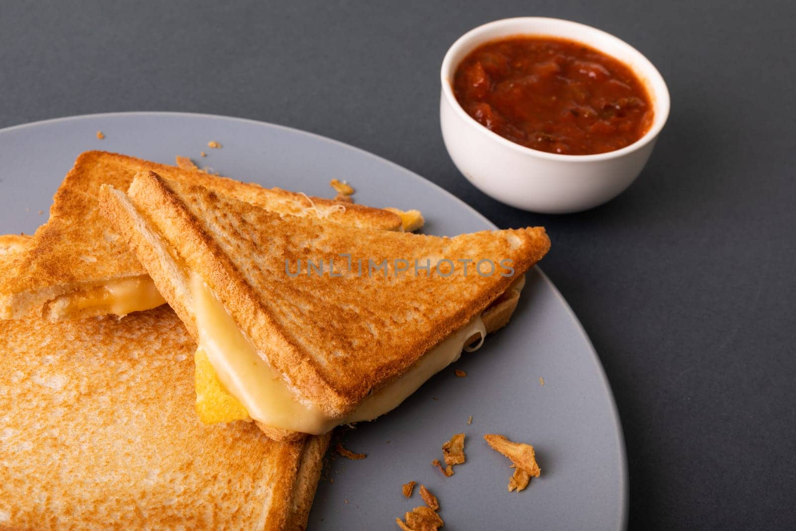 High angle view of fresh cheese sandwich toast served in plate by dip. unaltered, food, unhealthy eating and snack concept.