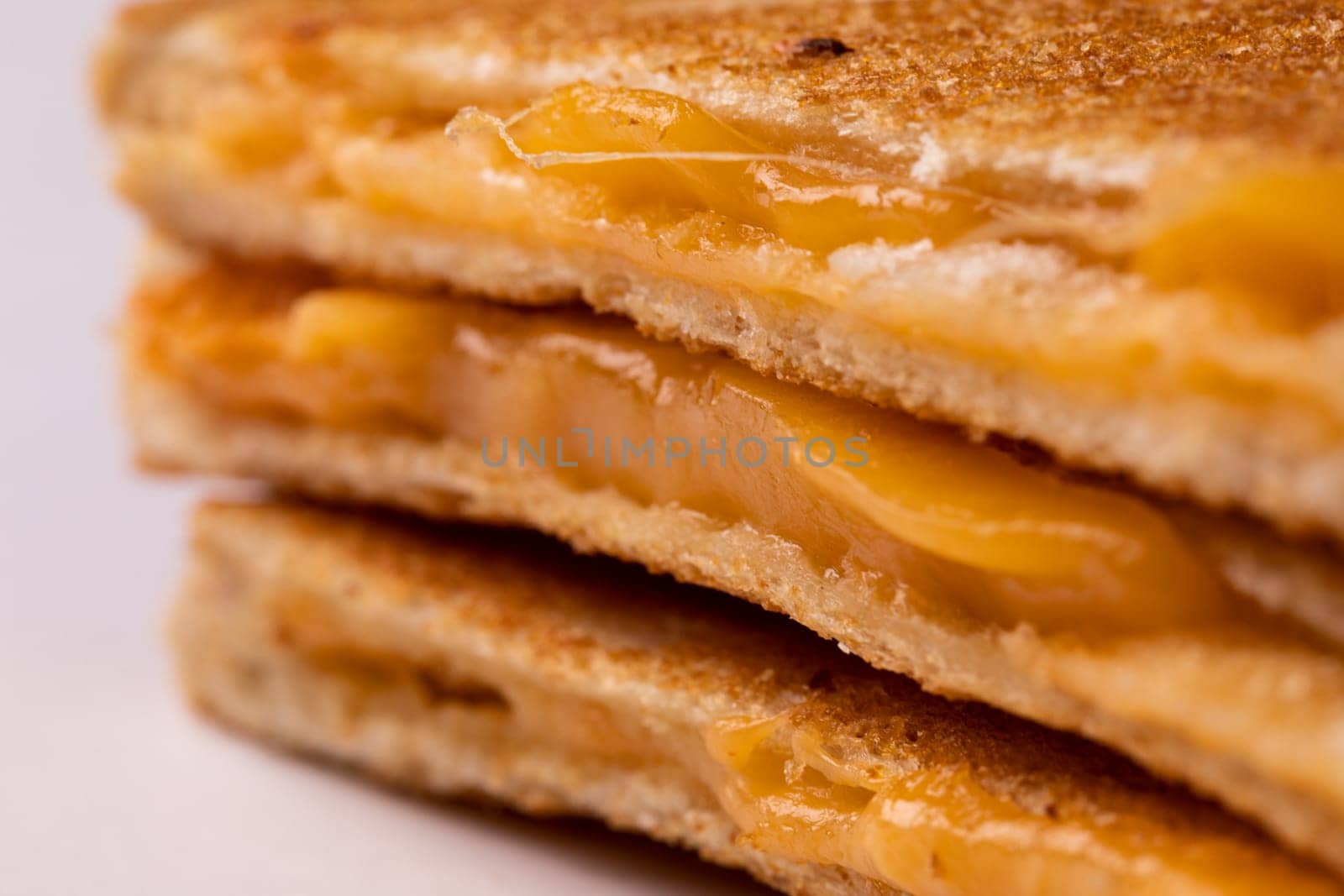 Close-up of fresh melting cheese in toast sandwich by Wavebreakmedia