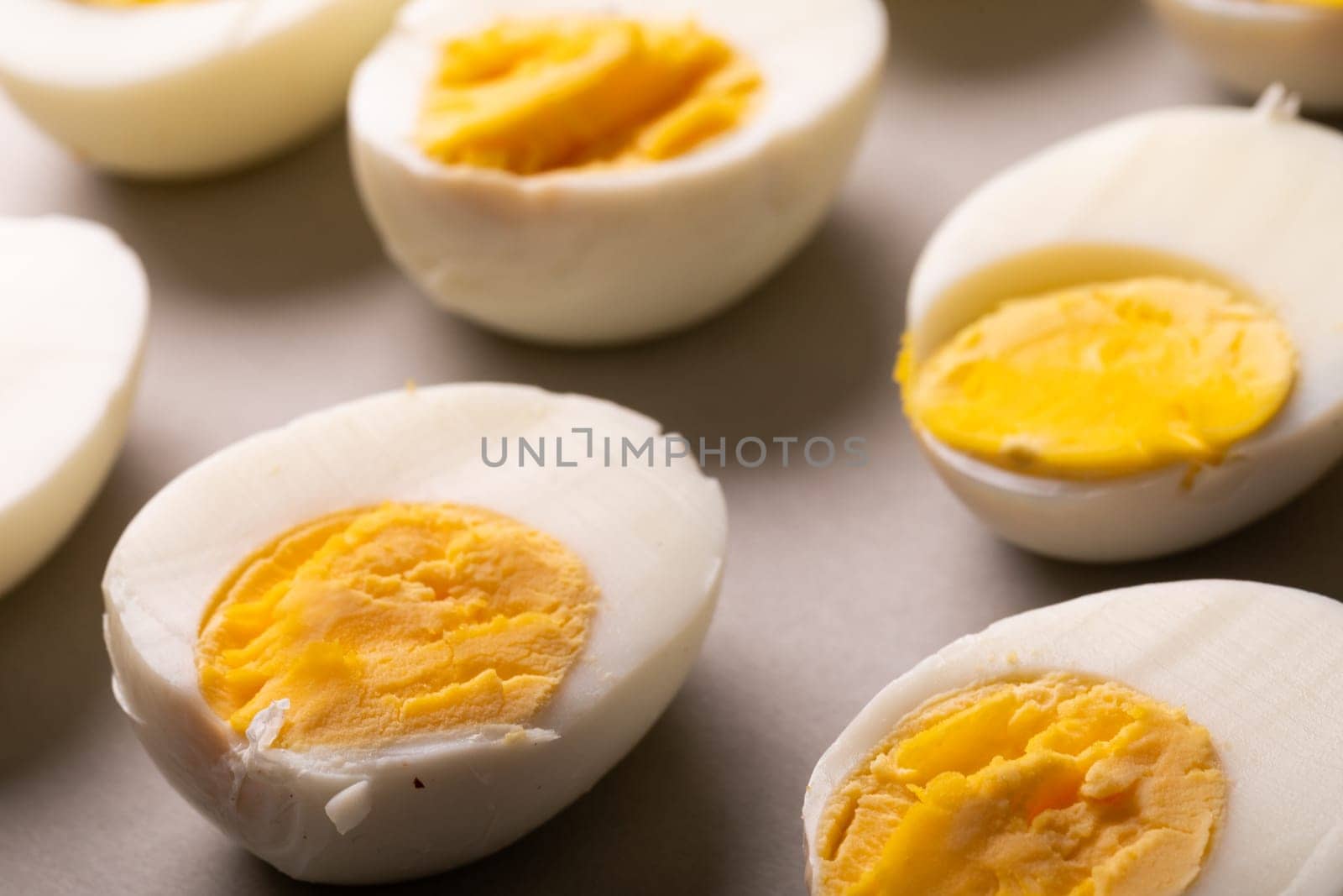 High angle view of fresh white boiled eggs with yellow yolks on table by Wavebreakmedia