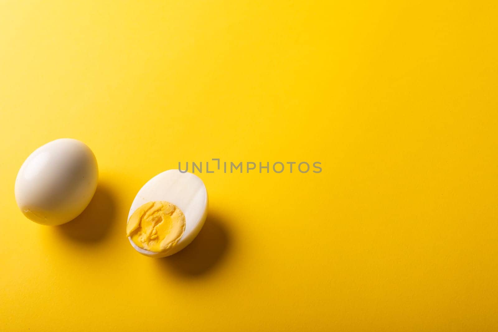 High angle view of fresh boiled white eggs by copy space against yellow background. unaltered, food, healthy eating and organic concept.