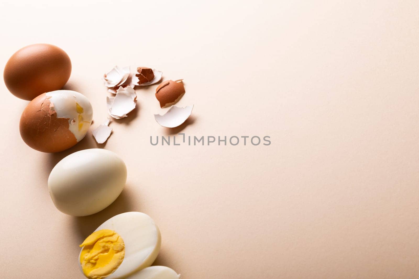 High angle view of fresh brown and white boiled eggs by copy space on pink background by Wavebreakmedia