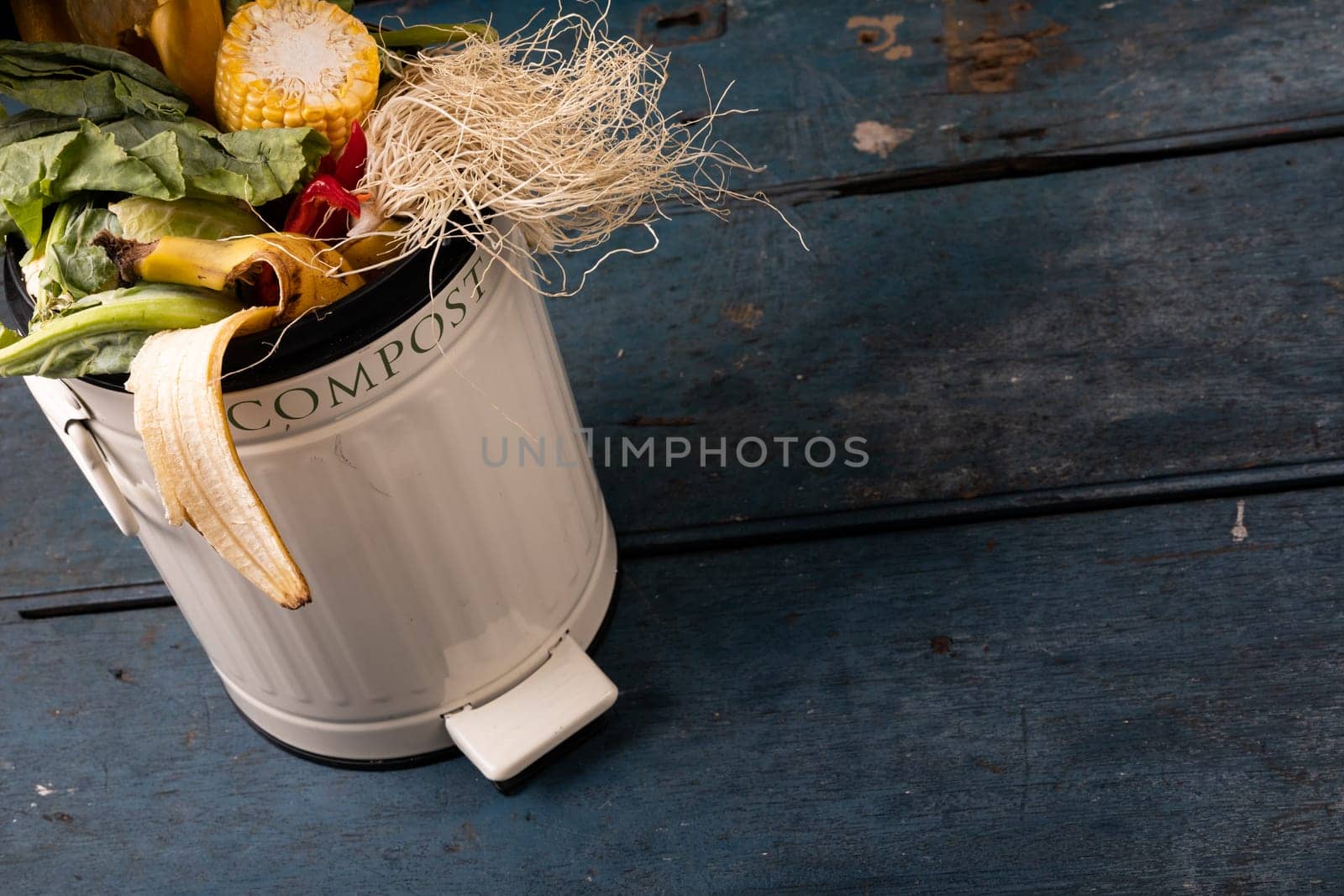 High angle view of organic rubbish in compost bin on wooden table. unaltered, decomposing, recycling, responsibility and environmental conversation concept.