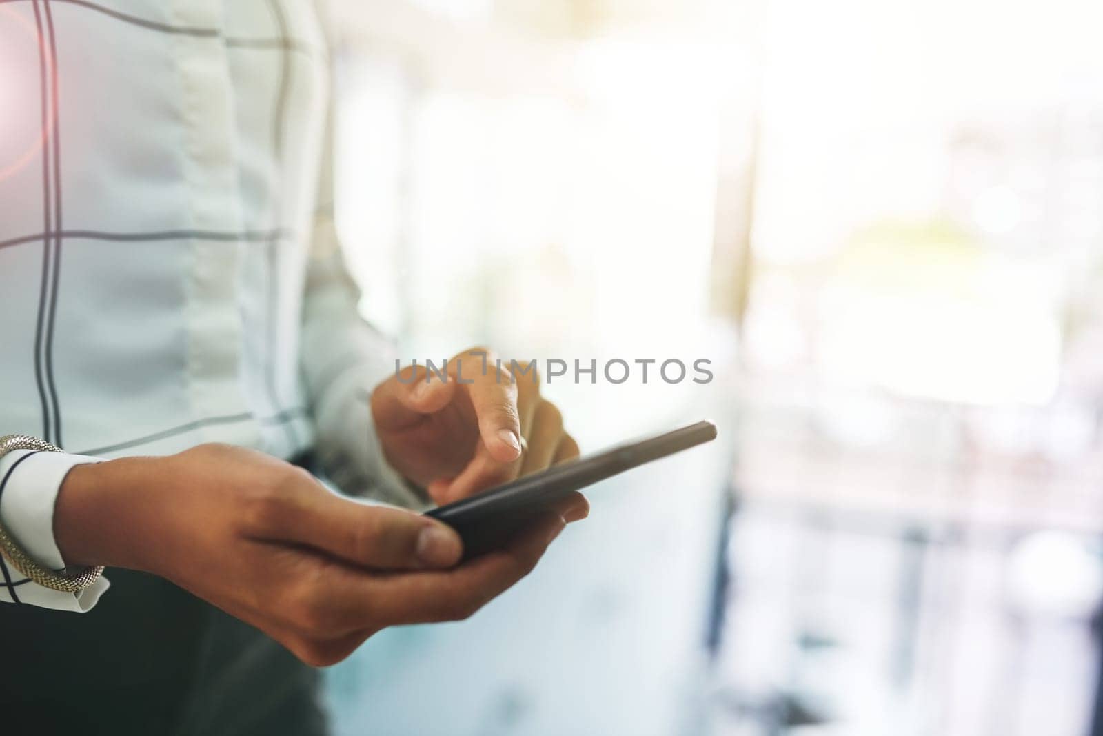 Shes starting the conversation. Closeup shot of an unrecognizable businesswoman using a cellphone in an office