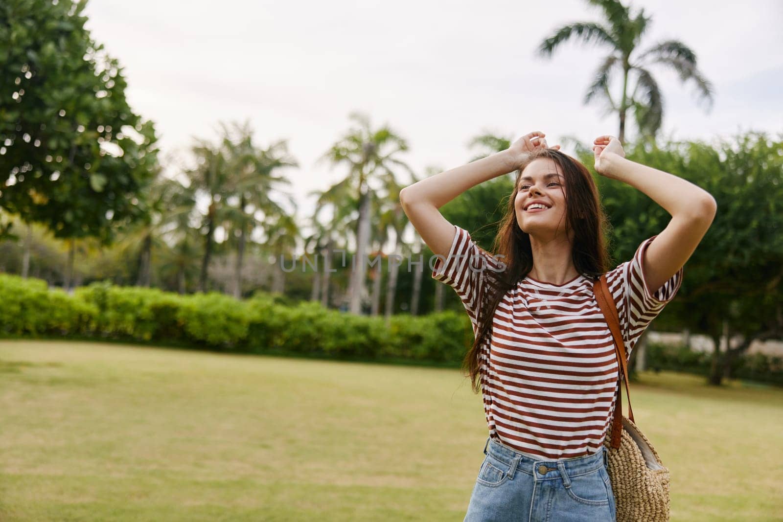 woman walk long wellness smiling joy nature sunset park young sun black t-shirt hair beautiful summer freedom quiet lifestyle striped beauty carefree