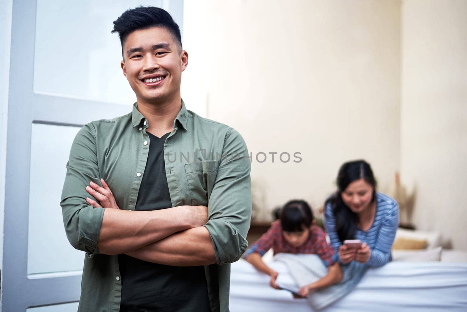 Family time is important. Portrait of a young man relaxing with his family at home