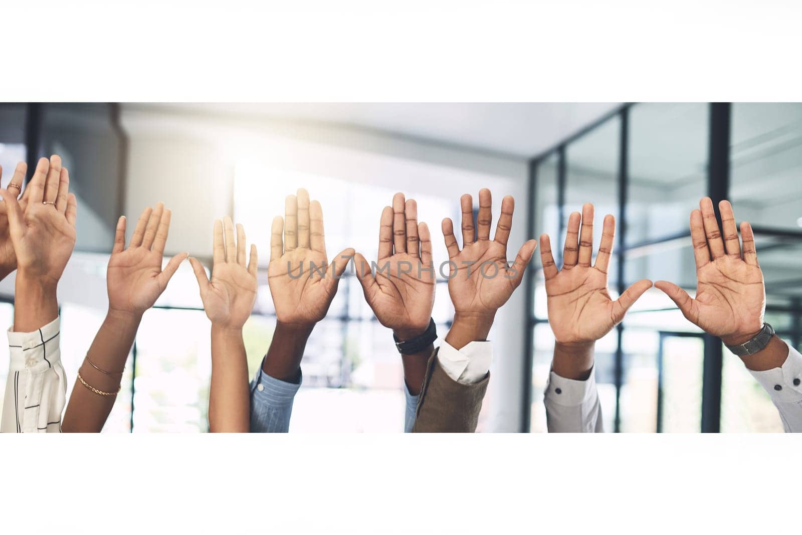 Have your voice heard. Closeup shot of a group of businesspeople raising their hands in an office. by YuriArcurs
