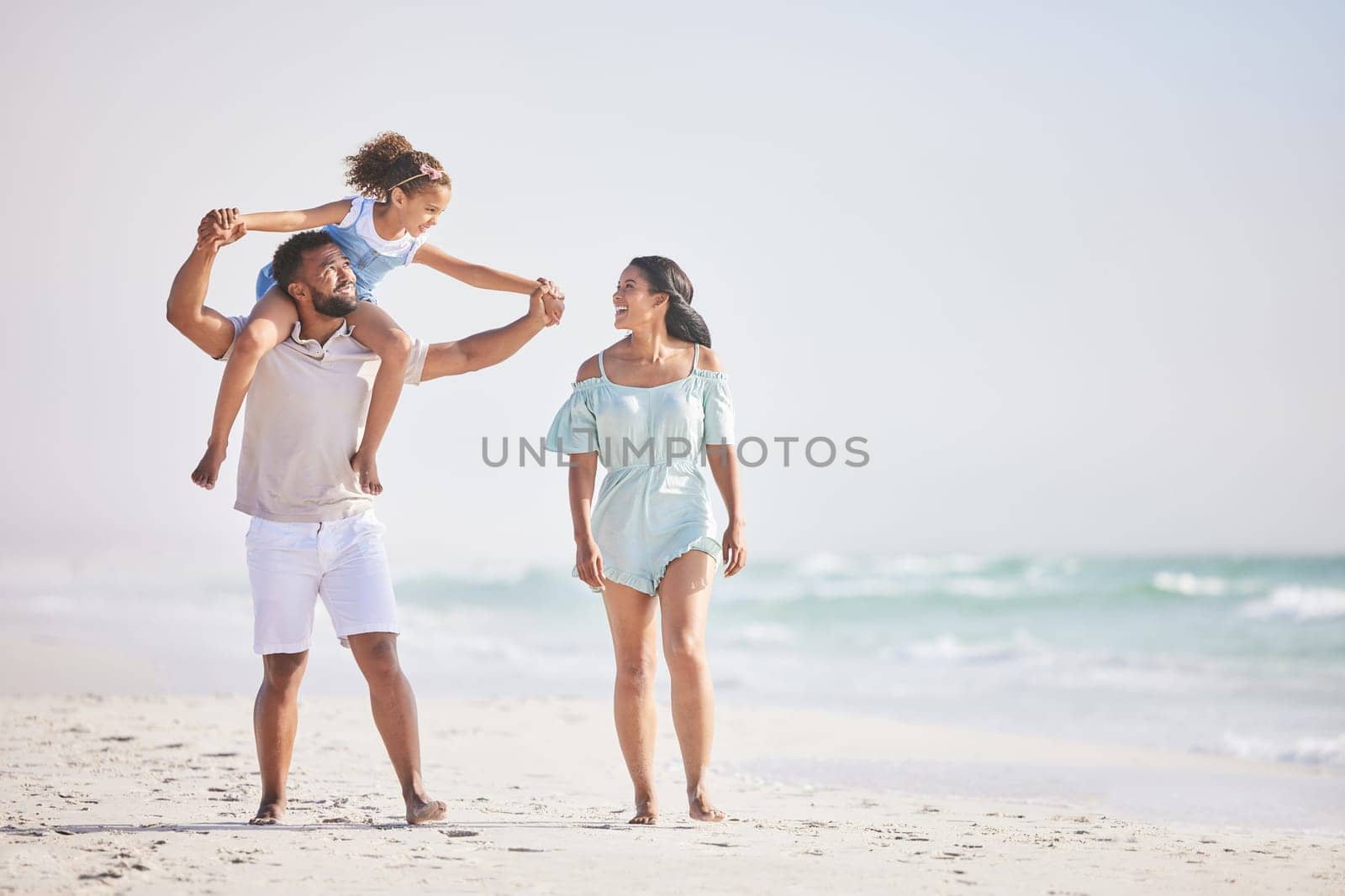 Holding hands, beach or parents walking with a girl for a holiday vacation together with happiness. Piggyback, mother and father playing or enjoying family time with a happy child or kid in summer.