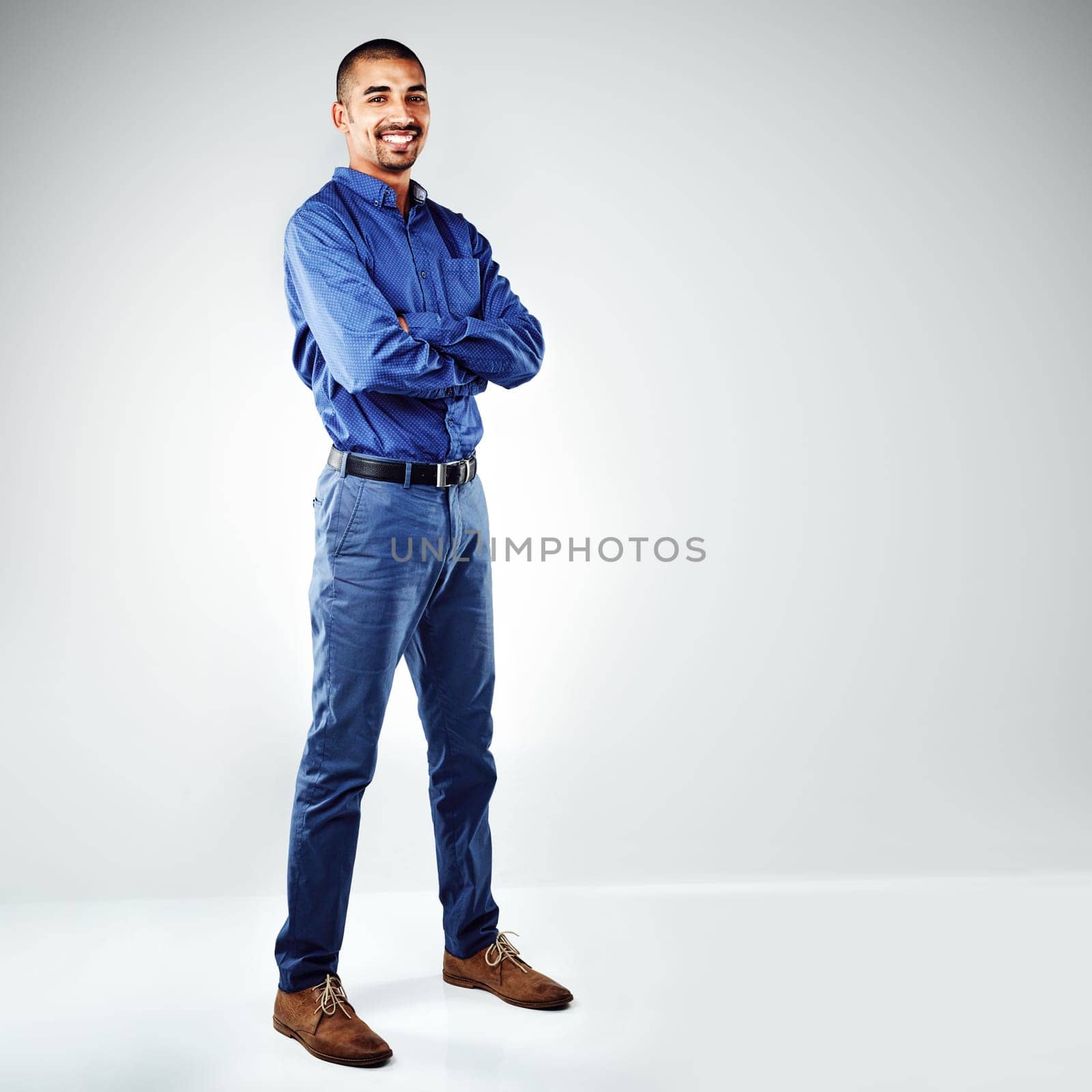 Make the leap to starting a business. a young businessman posing against a grey background