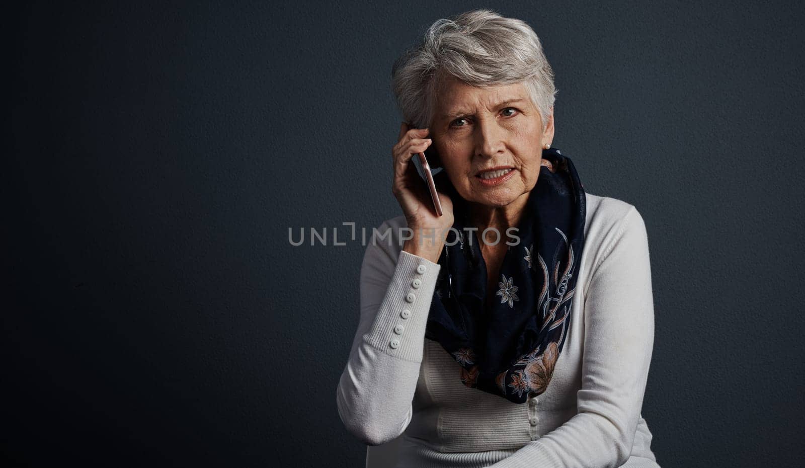 Youre asking for a food recipe. Studio shot of an elderly woman sitting down and talking on her cellphone