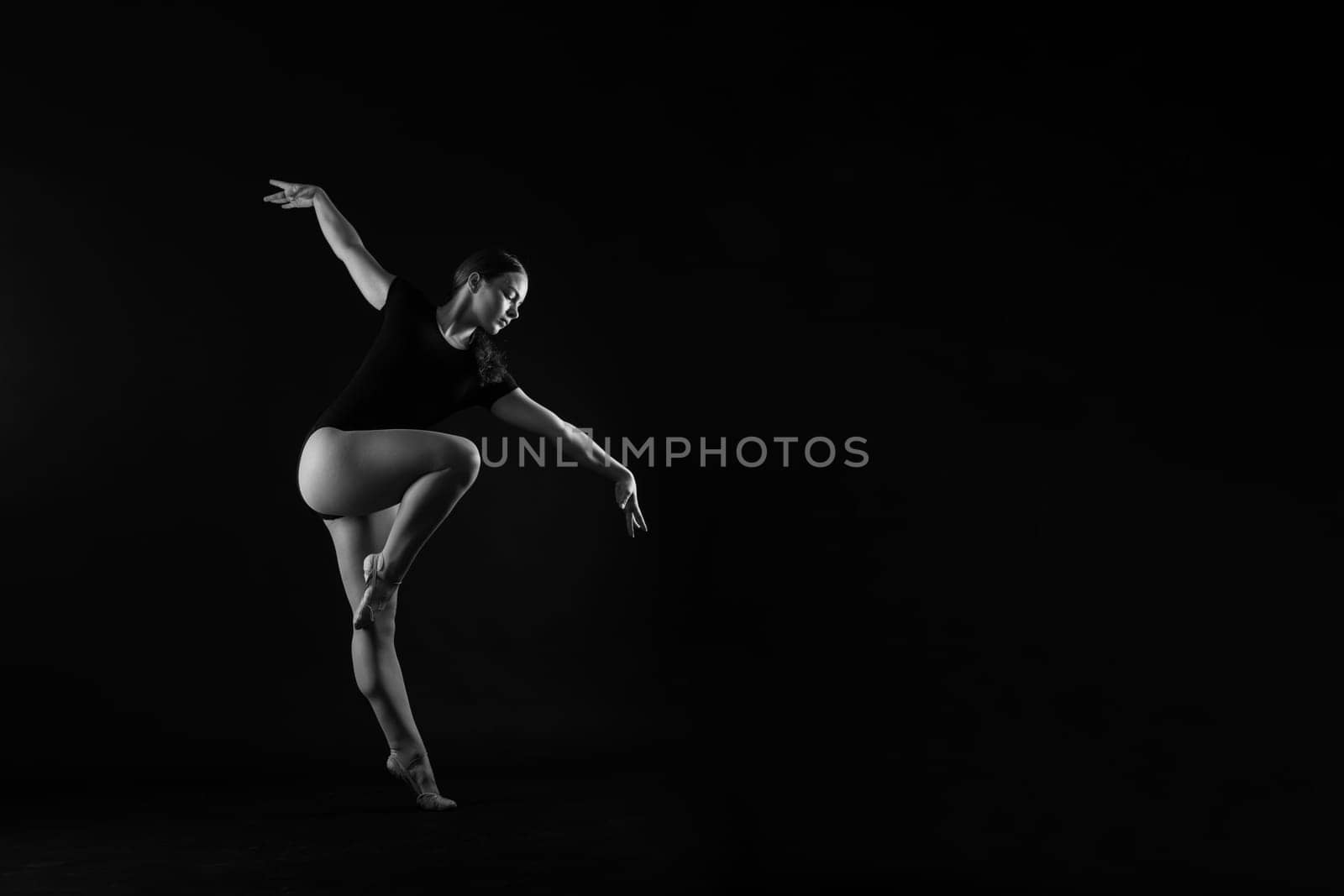 Sportive exercises, standing and stretching the hands. Beautiful muscular woman is indoors studio. by Zelenin