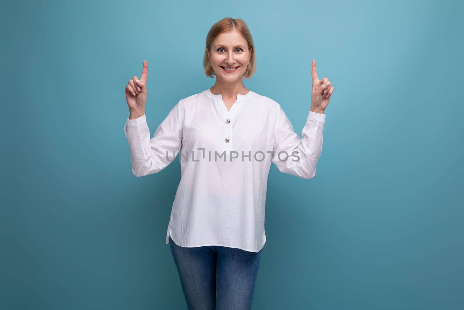 healthy well-groomed blond middle-aged woman in a white blouse.