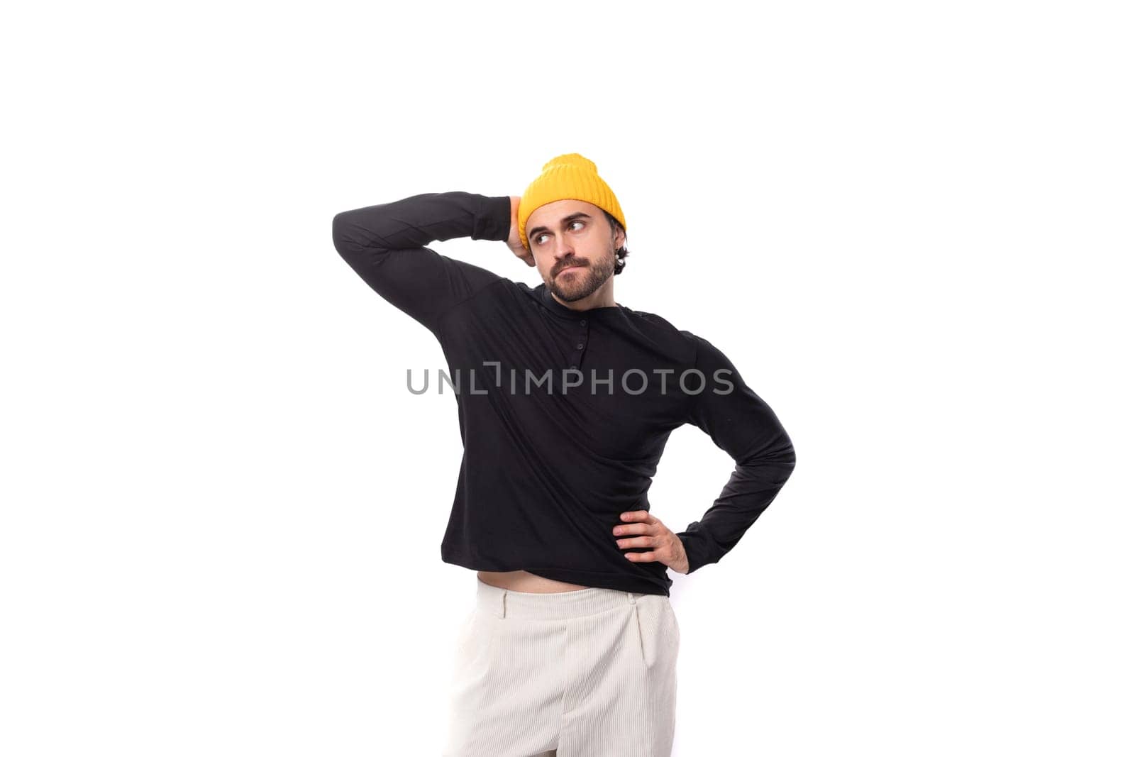 young brutal caucasian brunette man with beard in casual sweatshirt isolated on white background with copy space.