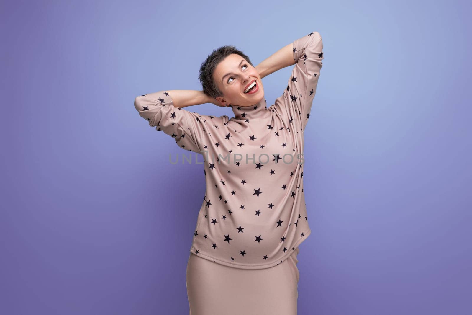 successful well-groomed young career woman with gray streaked hair dressed in a skirt and blouse posing against the backdrop of copy space by TRMK