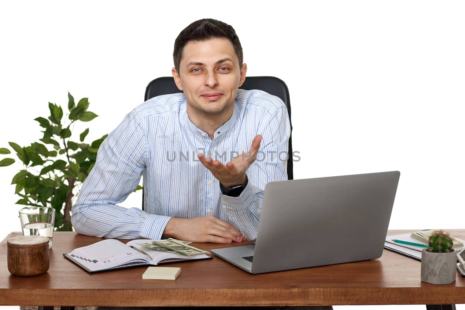 smiling man looking at the camera, using laptop computer for online work at table on white background