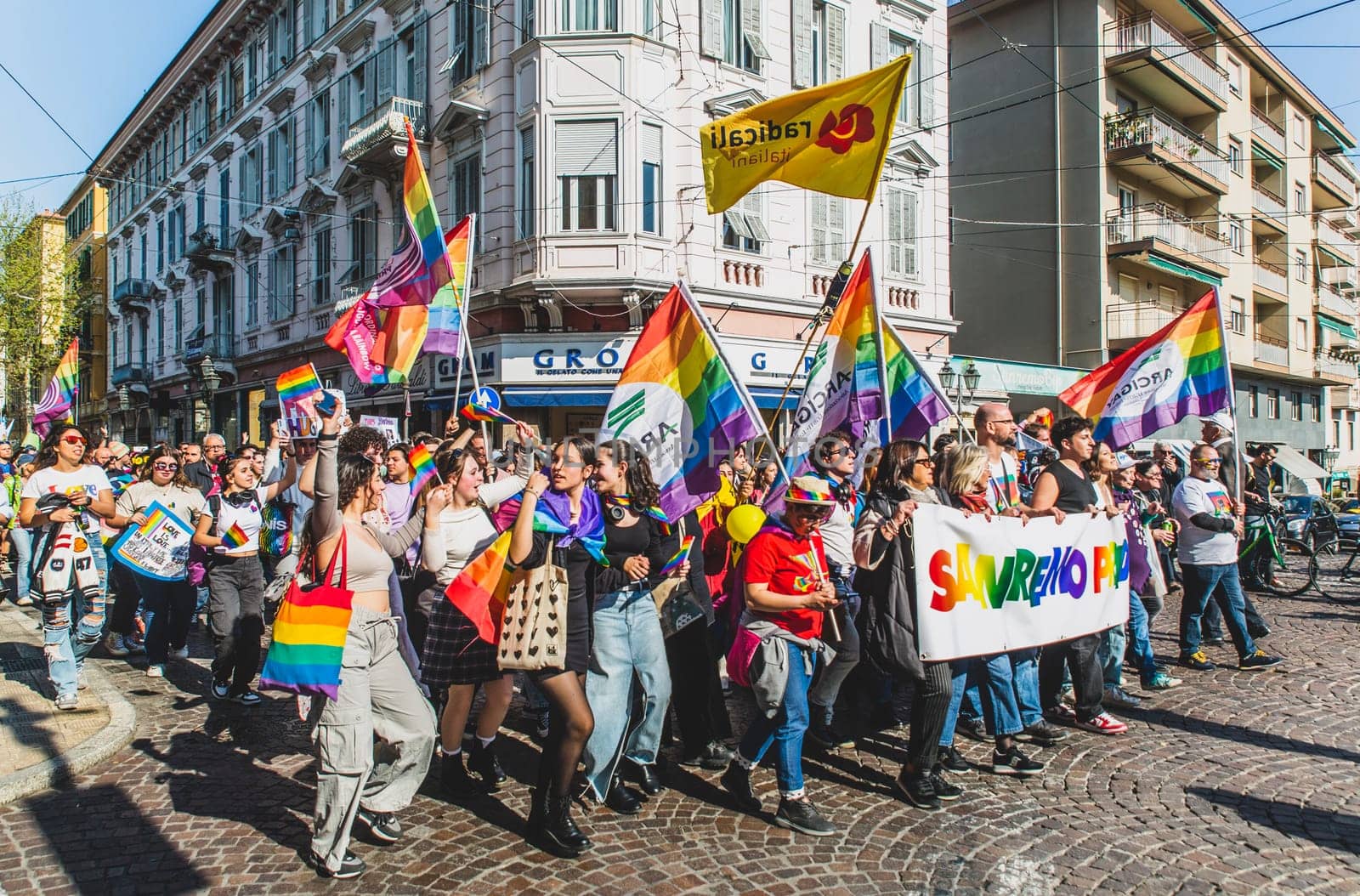 Reporting by journalists on the LGBT pride event held in Sanremo, where attendees enjoy themselves and march in the streets.