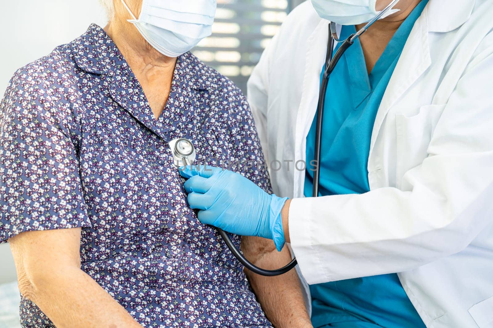 Doctor using stethoscope to checking the patient lie down on a bed in the hospital, healthy strong medical concept. by pamai