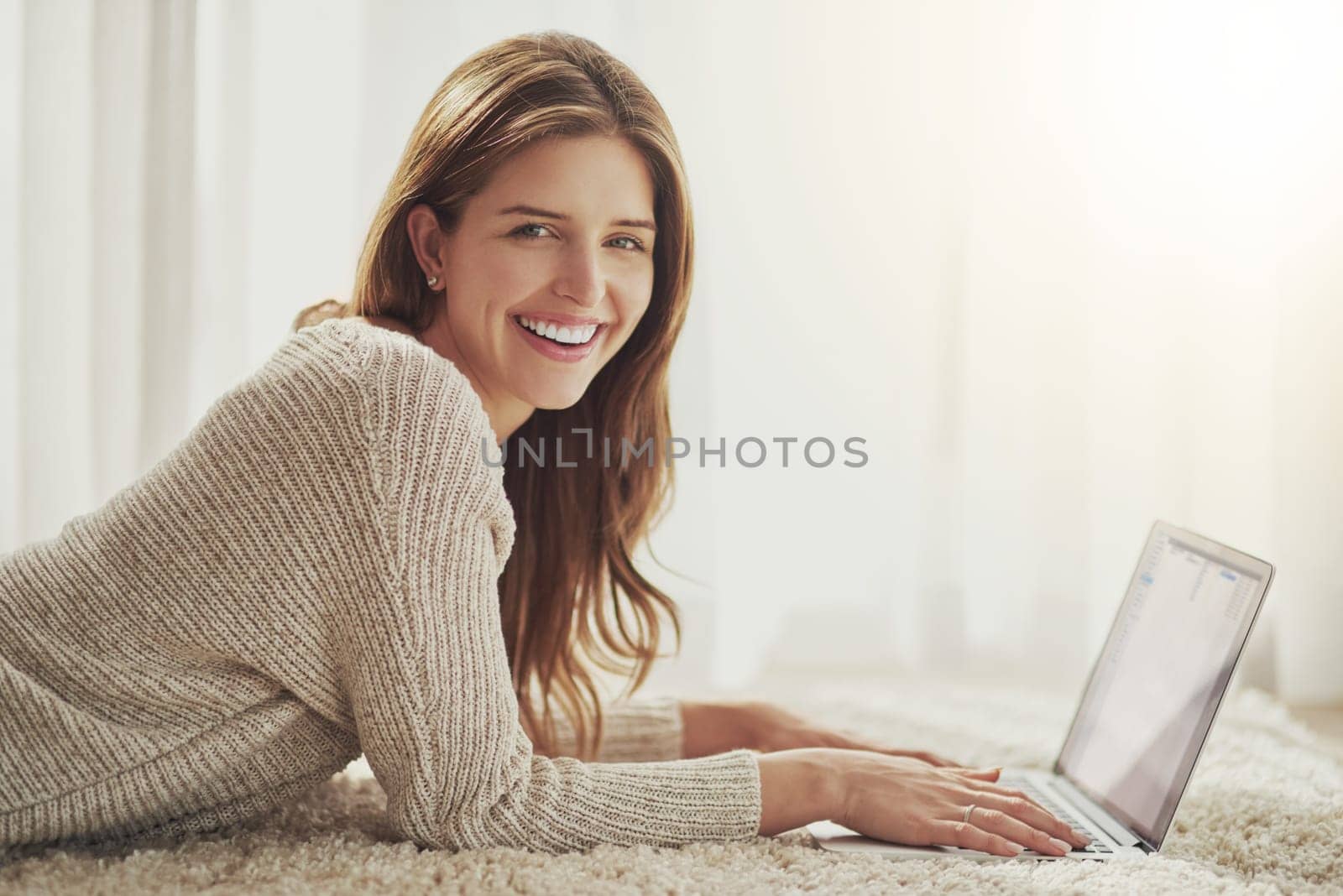 Happy, laptop and portrait of woman on carpet in home, relax or lying on floor. Computer, face smile and person on ground typing, writing blog for social media or email, internet or website in Norway by YuriArcurs