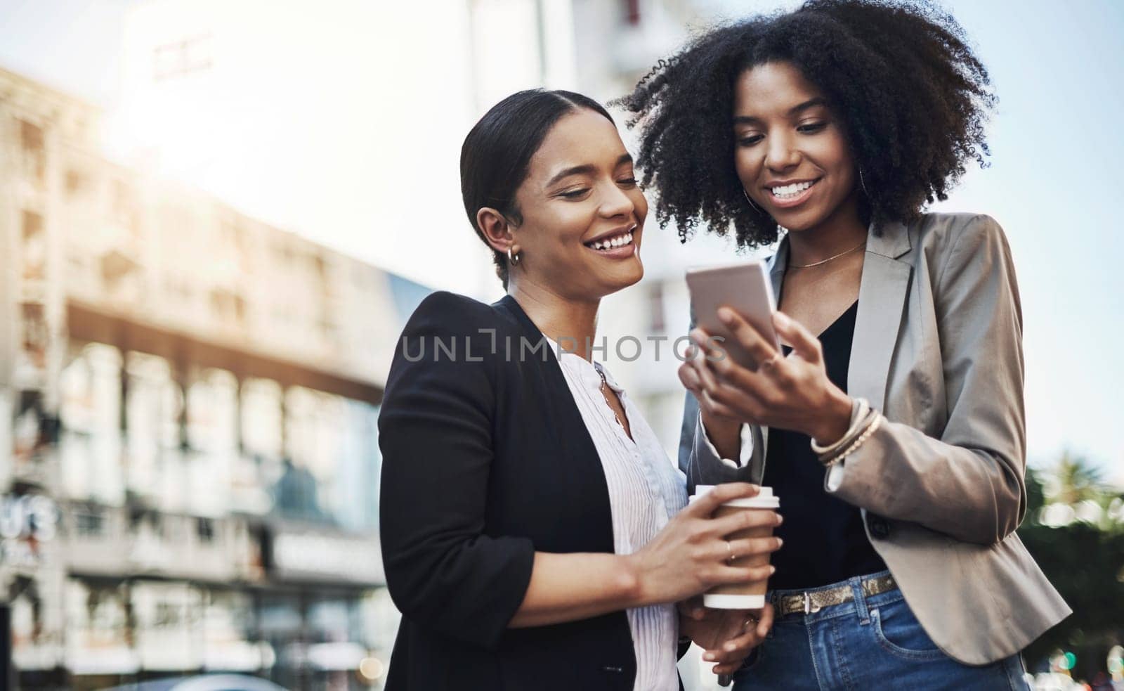 Business people, phone and city for social media, communication or team collaboration outdoors. Happy woman employees or friends with smile on mobile smartphone for networking or travel in urban town by YuriArcurs