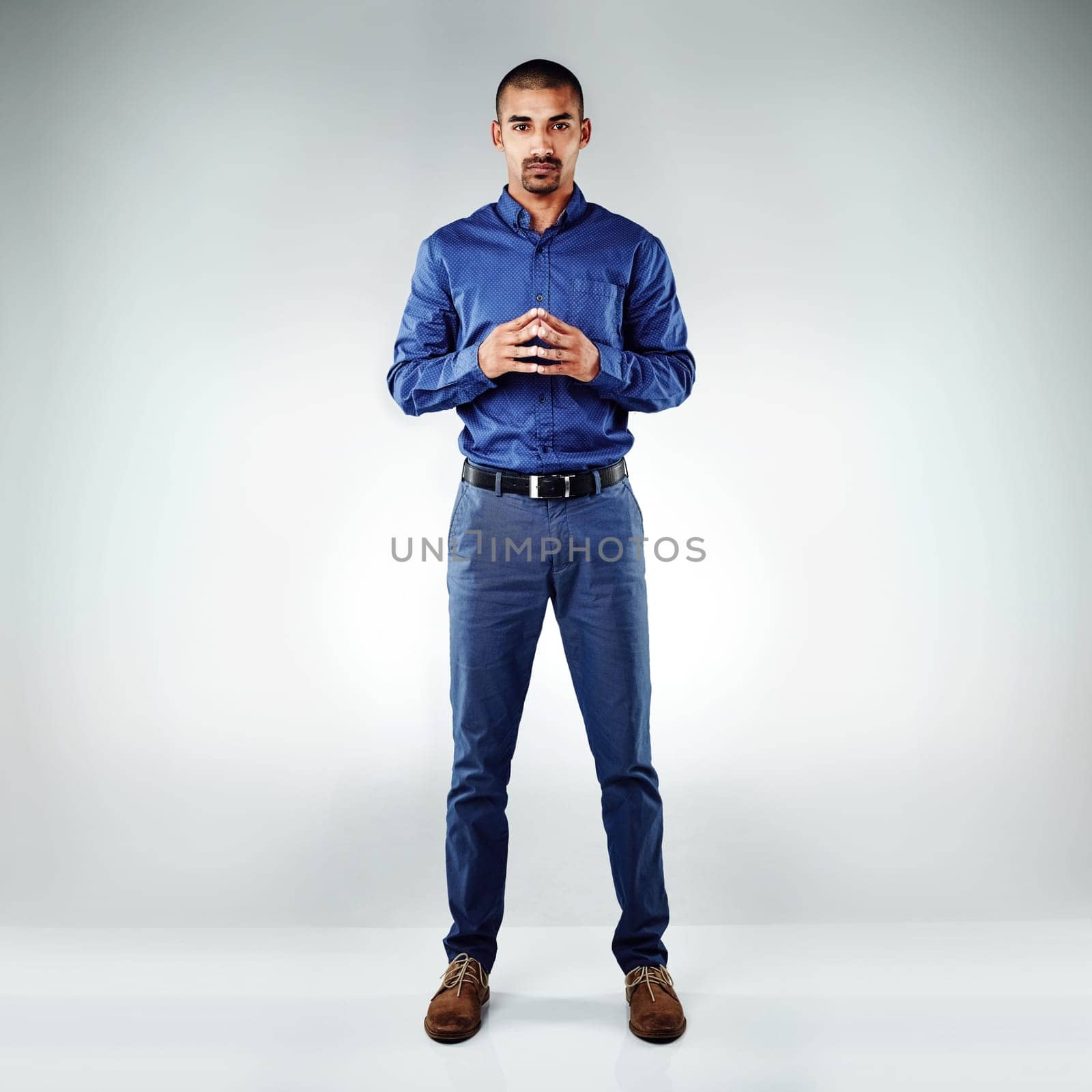 Perseverance is the one thing thats guaranteed to move anything. a young businessman posing against a grey background