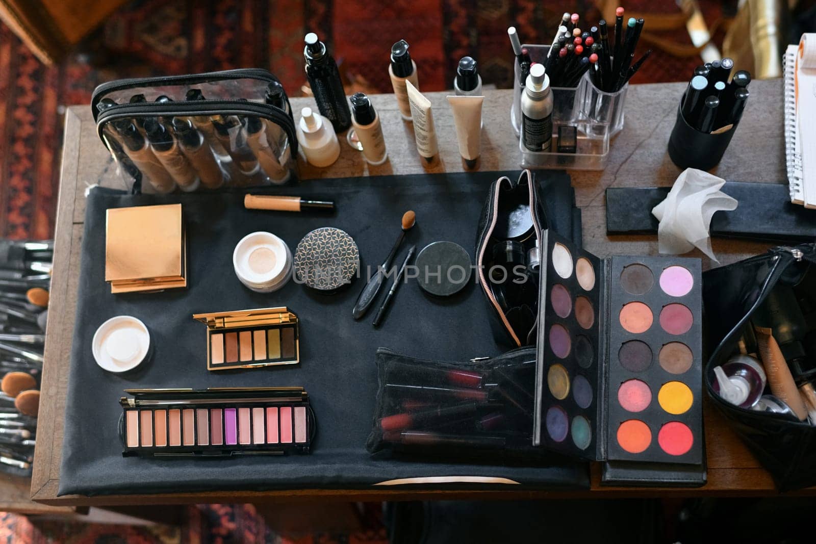The cosmetics on the table lipstick foundation brush shadow