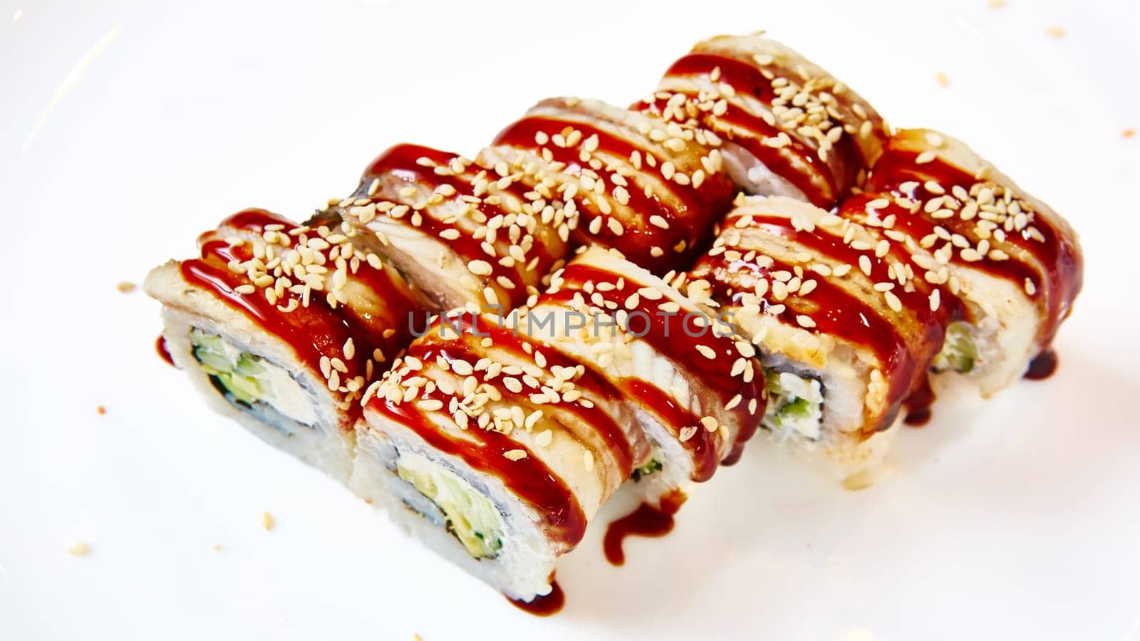 Unagi Sushi rolls. Sushi with eel, cream cheese and avocado, sprinkled with white and black sesame seeds by sarymsakov