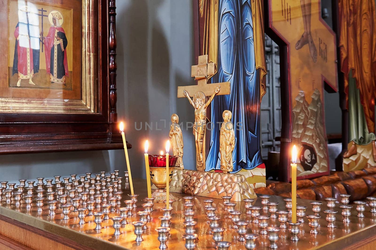 Kolomna, Russia - May 30, 2023: Burning candles in the Russian Orthodox Church. Interior of Russian Orthodox Church