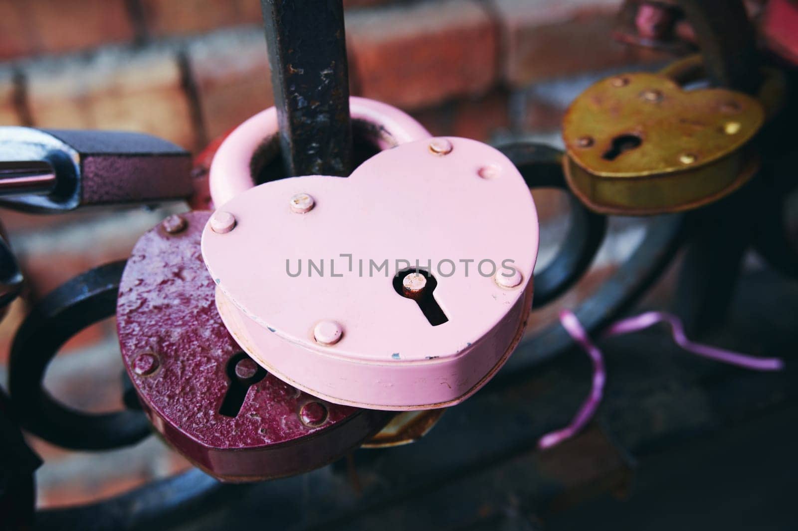 Door lock in the shape of a heart on a metal fence