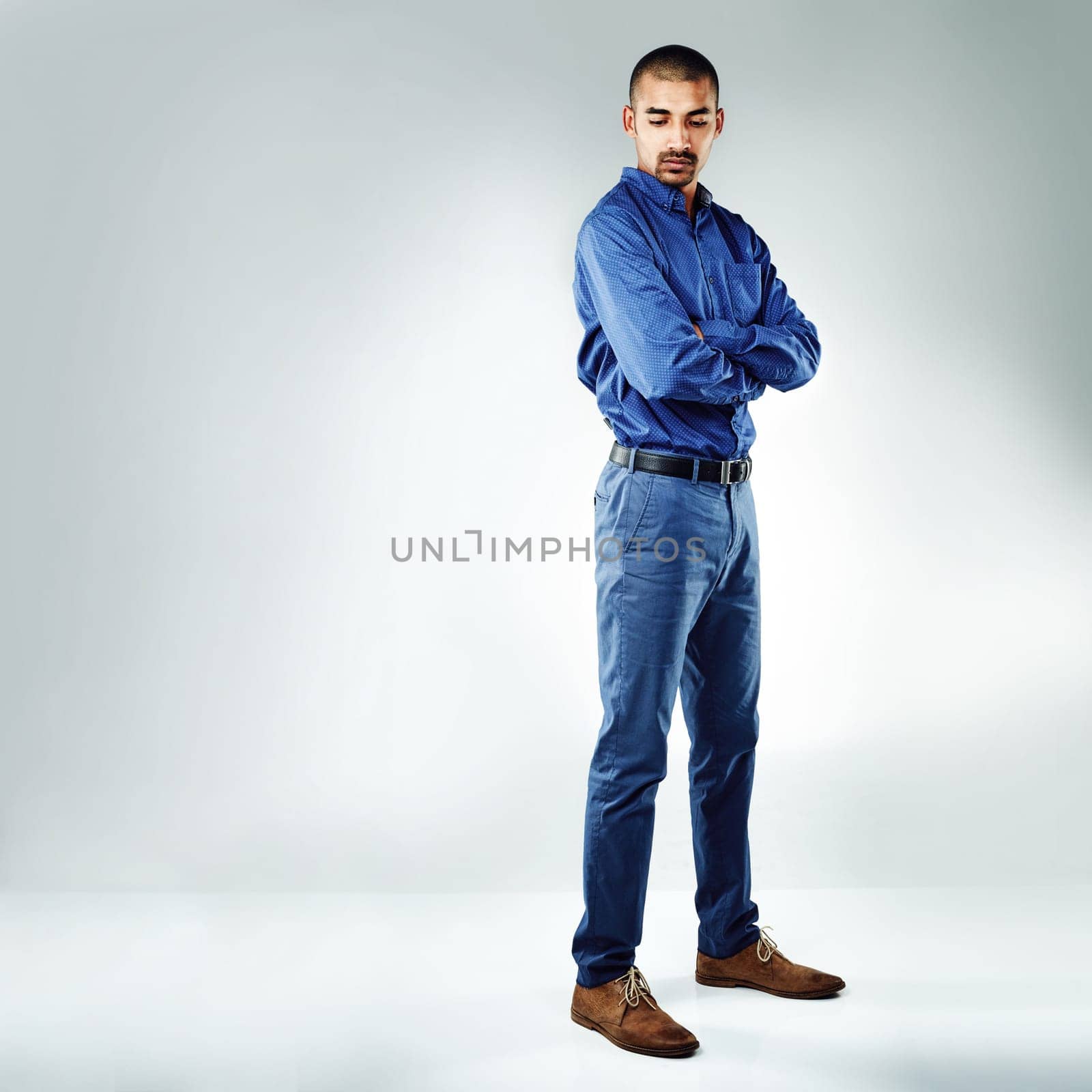 Do you have what it takes to get through hard times. a young businessman posing against a grey background