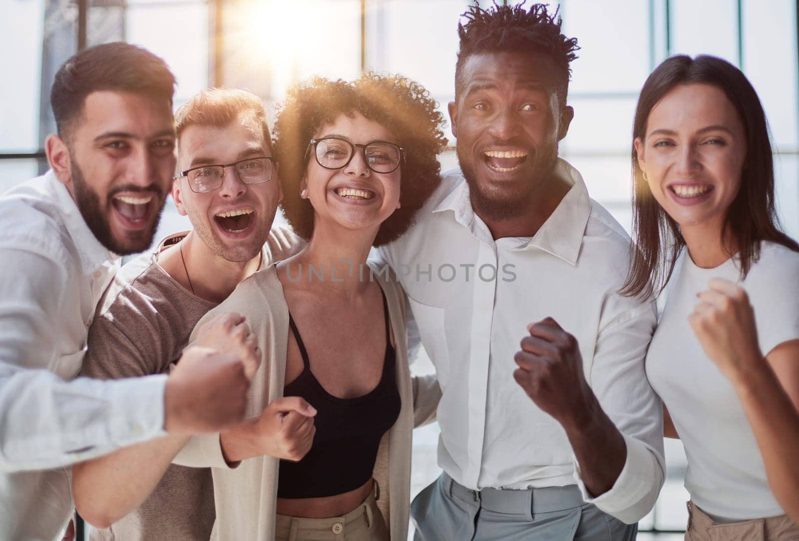 Portrait of successful creative business team looking at camera and smiling. Diverse business people standing together at startup.