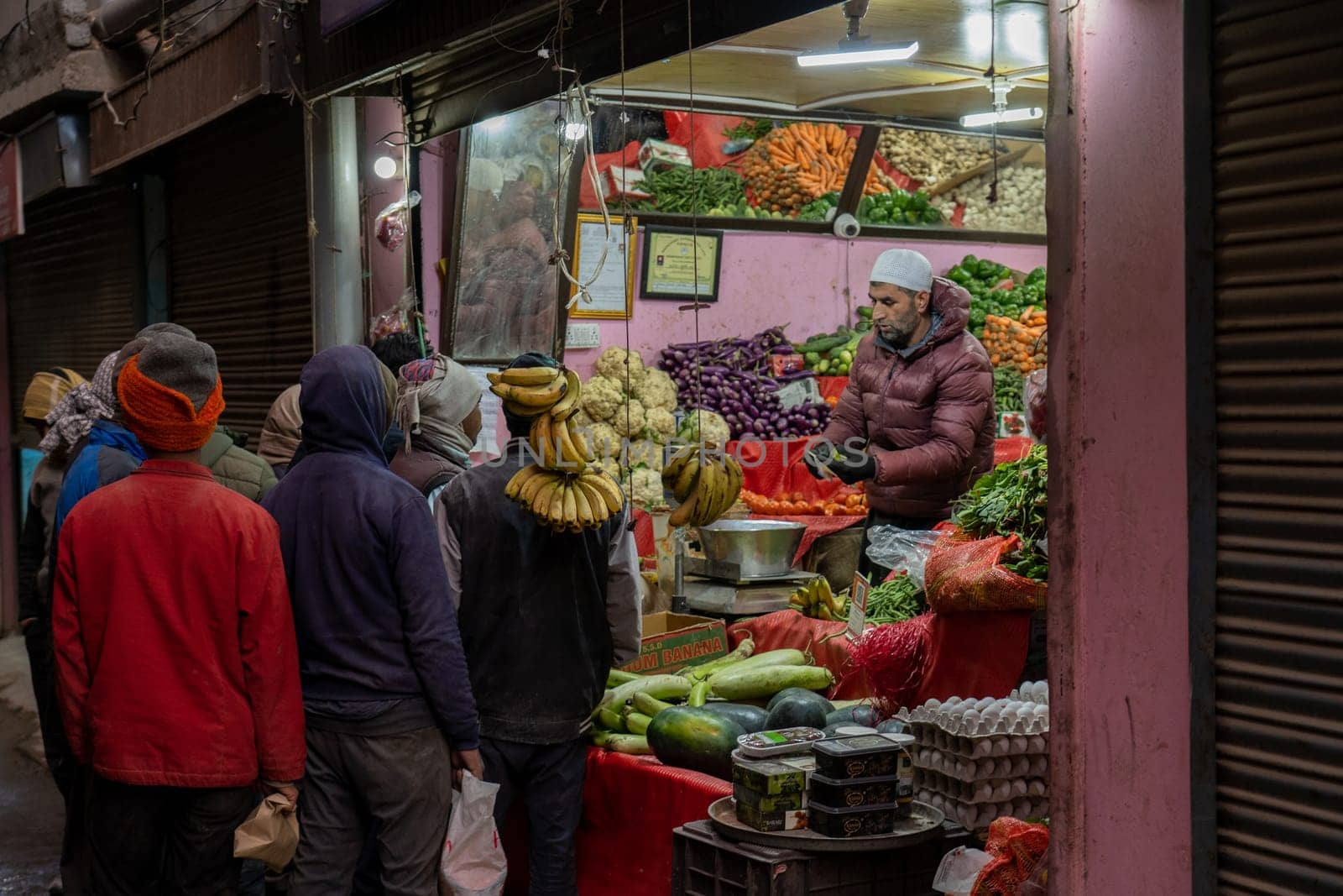 Leh, India - April 4, 2023: People at a fruit and vegetable shop in the historic city centre