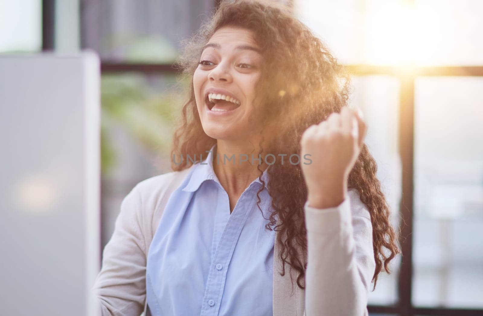 expressive young woman open mouth checking discounts for online shopping sitting at desktop .