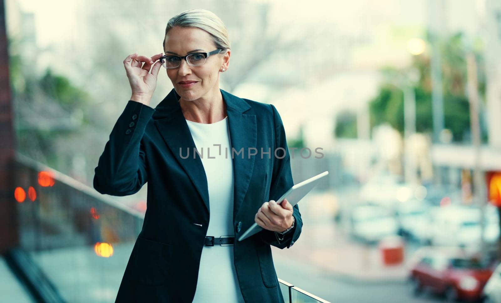 The successful have vision. Portrait of a mature businesswoman standing outside on the balcony of an office and holding a digital tablet. by YuriArcurs