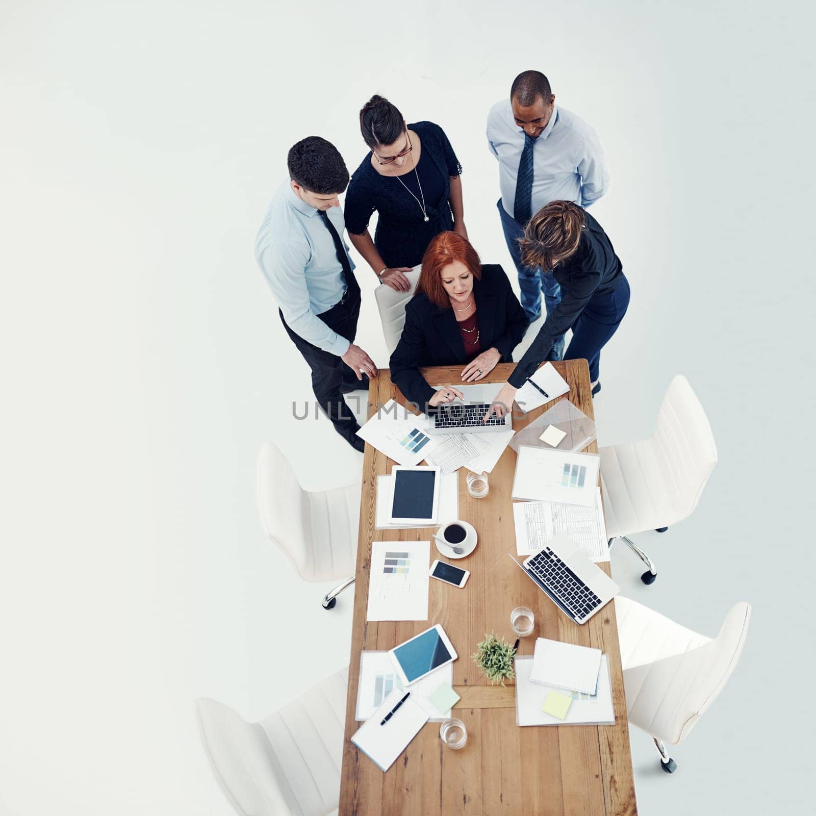 This is where we should focus our attention...group of businesspeople using a laptop together during a meeting in an office