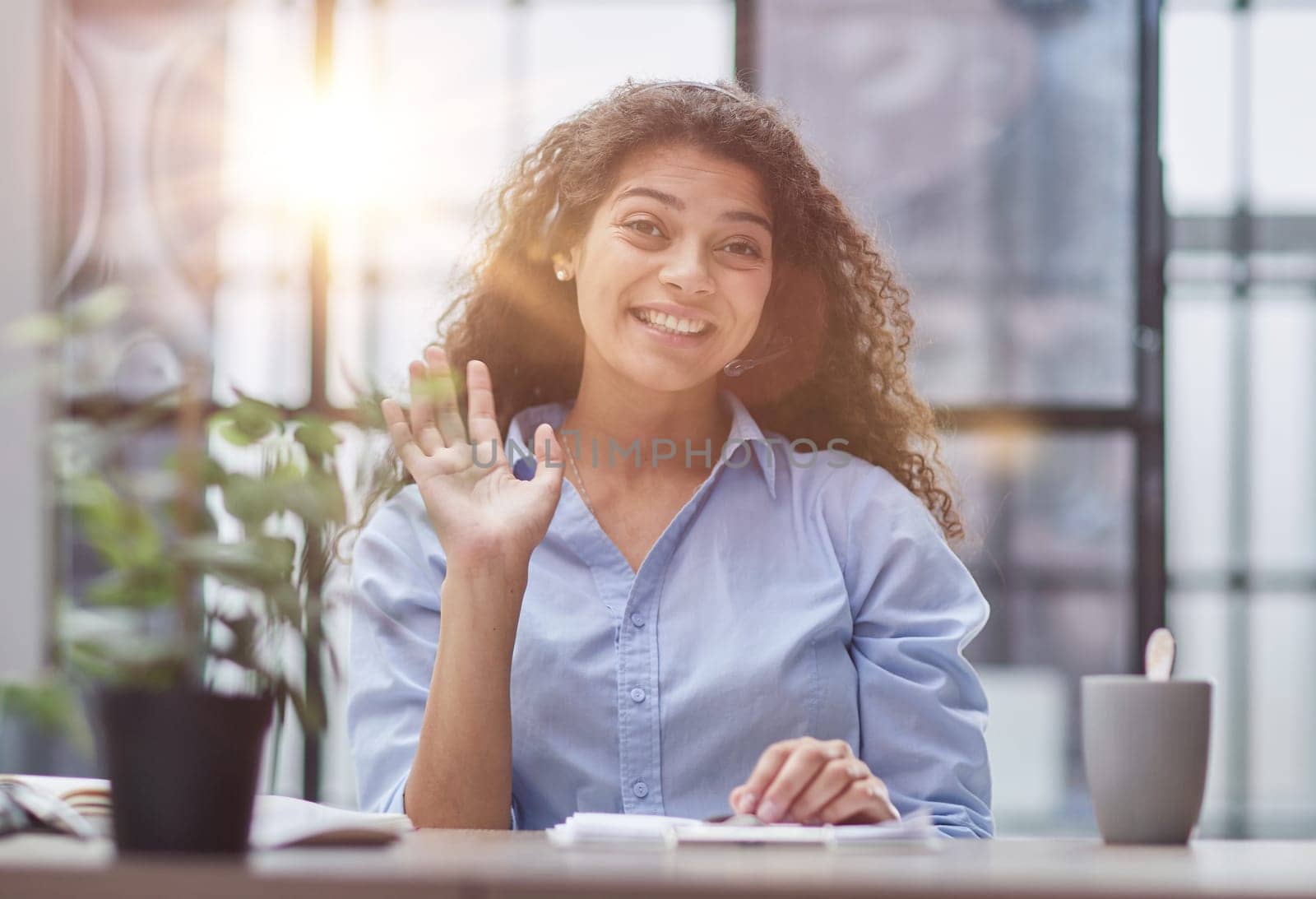 Smiling businesswoman or helpline operator with headset and computer at office