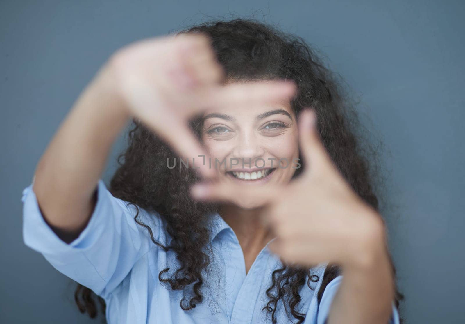 Photo of cheerful self-assured lady folded arms wear blue shirt grey color background
