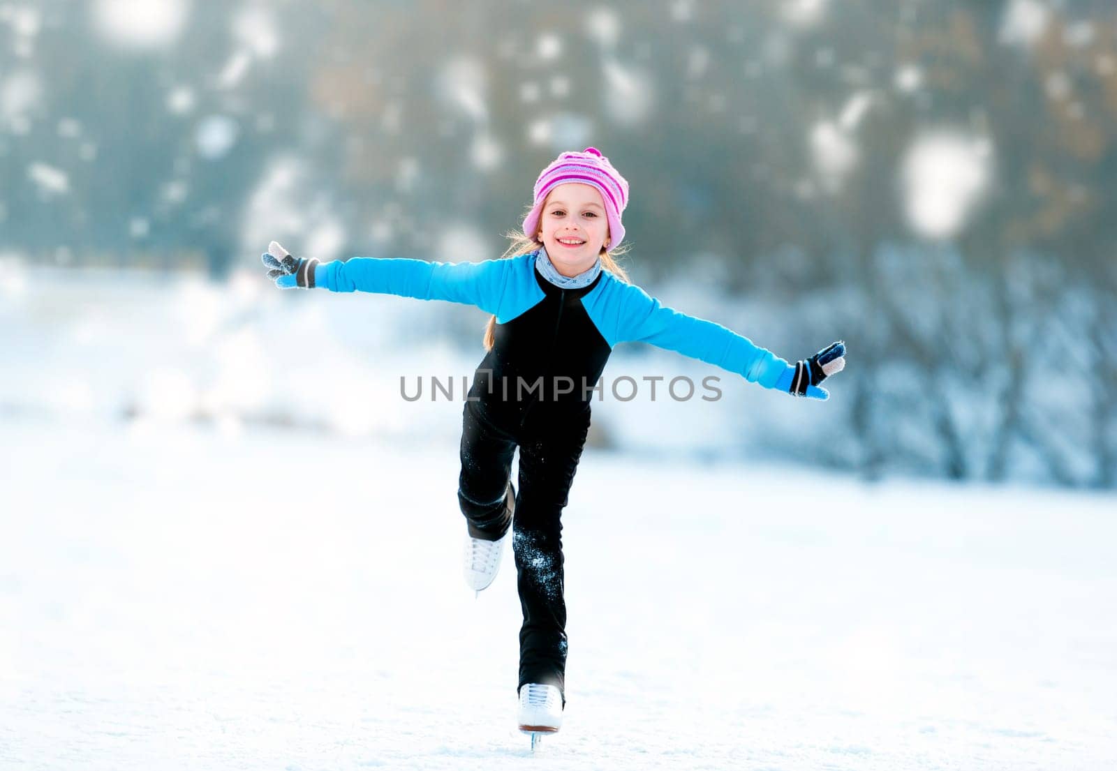 happy cute little girl in thermal suits skating