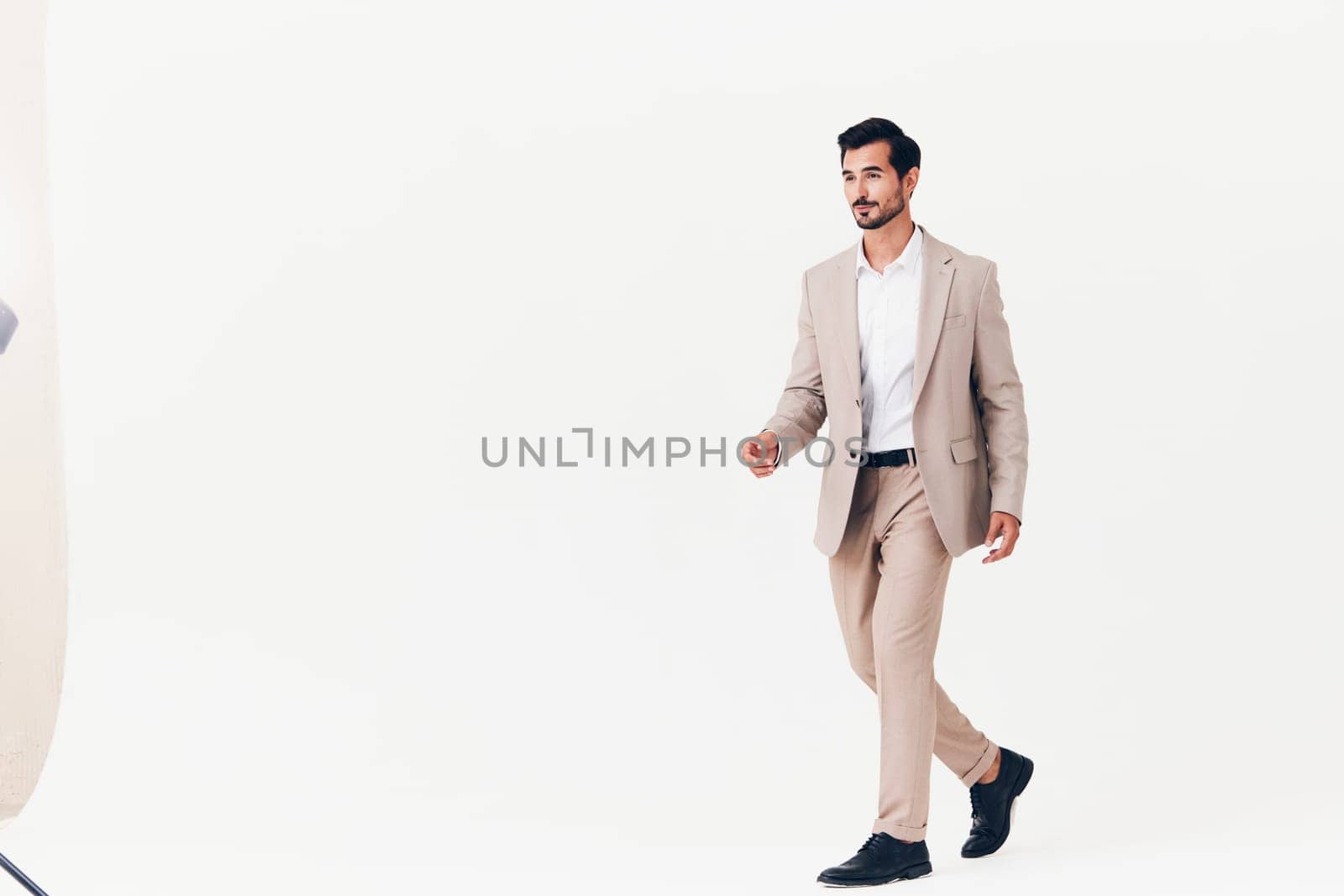 man winner victory cheerful adult beard isolated flying business jacket standing occupation smiling happy jumping running attractive office beige businessman suit white