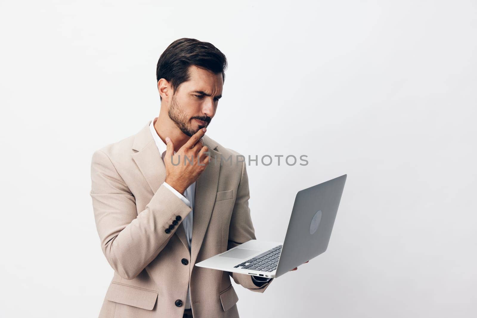 man typing online wireless entrepreneur internet adult suit model thoughtful using laptop computer working portrait male copyspace isolated freelancer business job