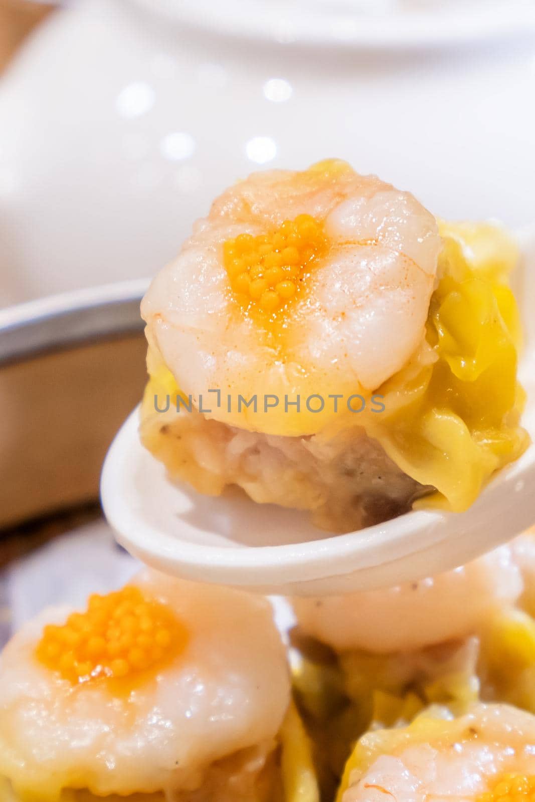 Siu Mai, one of Dim Sum yum cha, pork and shrimp steamed dumplings on restaurant house white background table for breakfast, lifestyle, close up. by ROMIXIMAGE