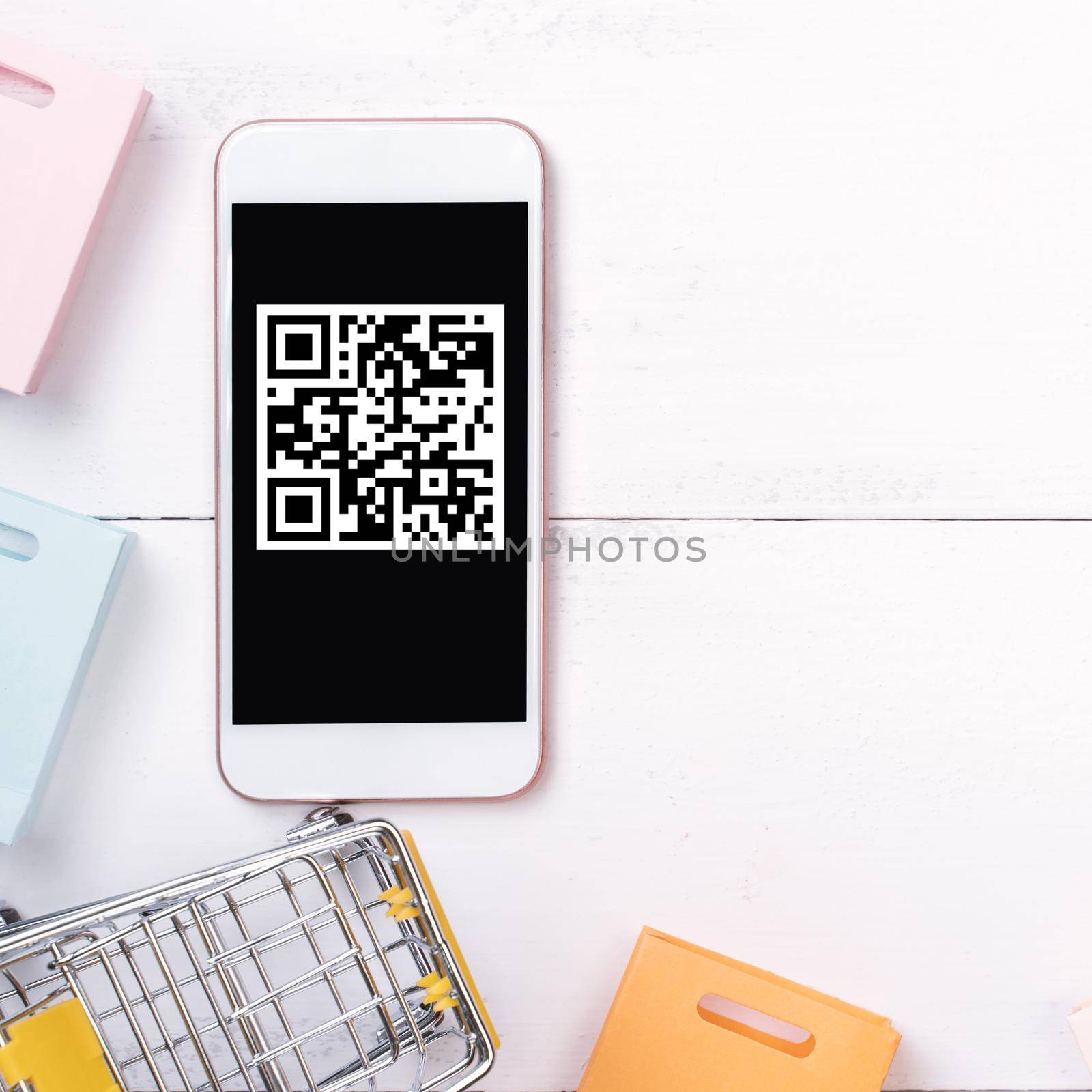 Abstract online shopping,mobile payment with QR code design concept element,colorful cart,paper bag on wooden table background,top view,flat lay