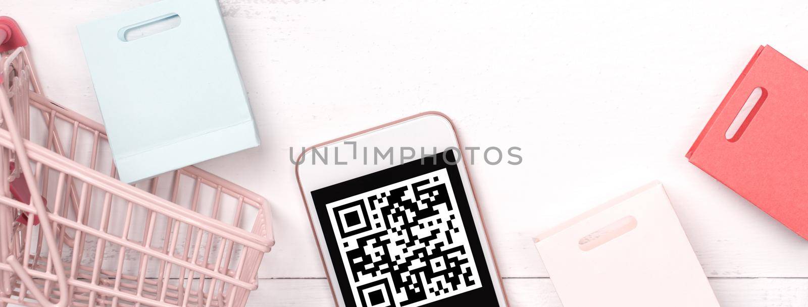 Abstract online shopping, mobile payment with QR code design concept element, colorful cart, paper bag on wooden table background, top view, flat lay