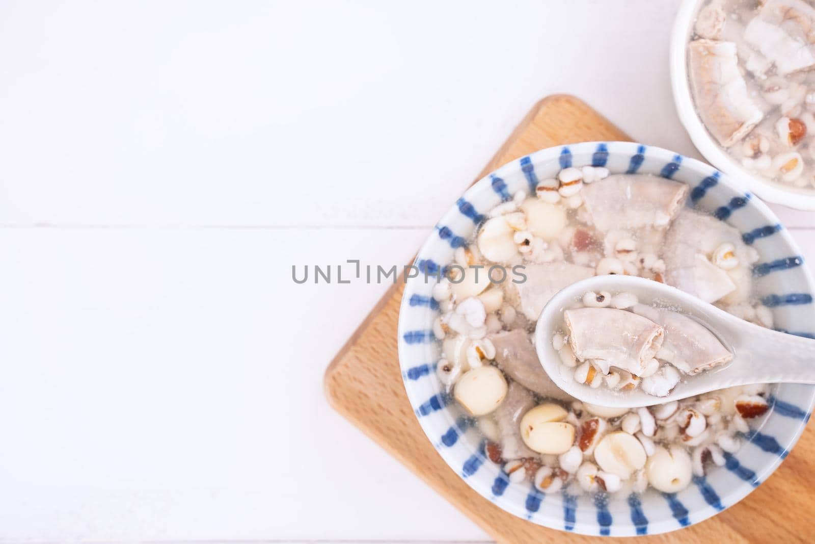Tasty Four Tonics Herb Flavor Soup, Taiwanese traditional food with herbs, pork intestines on white wooden table, close up, flat lay, top view.