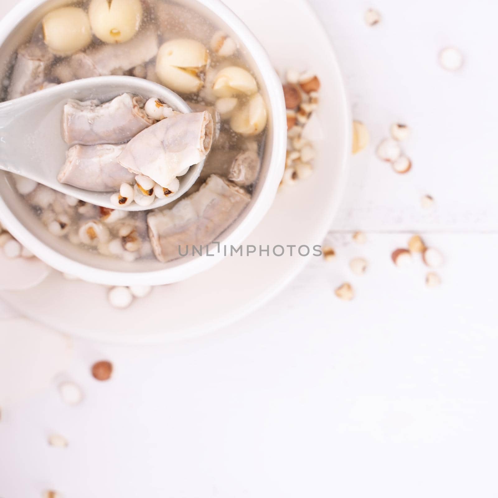 Tasty Four Tonics Herb Flavor Soup, Taiwanese traditional food with herbs, pork intestines on white wooden table, close up, flat lay, top view. by ROMIXIMAGE
