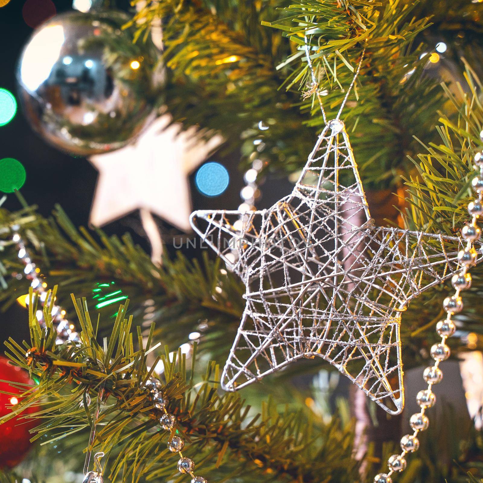 Beautiful Christmas decor concept, bauble hanging on the Christmas tree with sparkling light spot, blurry dark black background, macro detail, close up. by ROMIXIMAGE