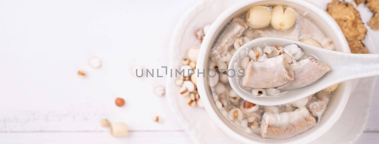 Tasty Four Tonics Herb Flavor Soup, Taiwanese traditional food with herbs, pork intestines on white wooden table, close up, flat lay, top view.