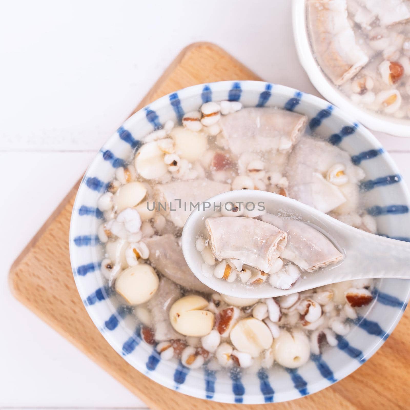 Tasty Four Tonics Herb Flavor Soup, Taiwanese traditional food with herbs, pork intestines on white wooden table, close up, flat lay, top view.